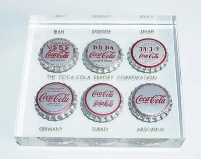 Pisapapeles transparente Coca-Cola Export Corporation 6 tapas de botellas de Coca-Cola International Foto 1 de 2