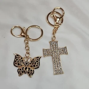 2er Set Schlüsselanhänger Taschenanhänger goldfarben Kreuz schwarz Strass Schmetterling Kristall - Bild 1 von 6