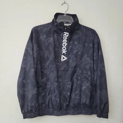 Chaqueta cortavientos Reebok negra cremallera completa prendas exteriores estampado geométrico camuflaje para mujer L Foto 1 de 4