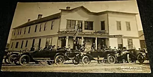 RPPC - Cartolina Hotel Hagenah sulla strada principale e OLD AUTOS, Roseau Minnesota - Foto 1 di 2