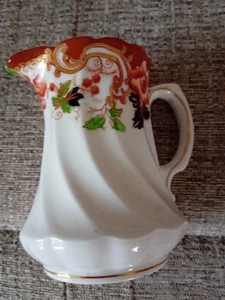 Pretty jug 10cm high fruit and leaf in dark blue, orange, gold pattern ridged - Picture 1 of 5