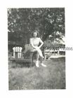 FOUND B&W PHOTO H_9456 PRETTY GIRL SITTING ON ARM OF OUTDOOR ARMCHAIR