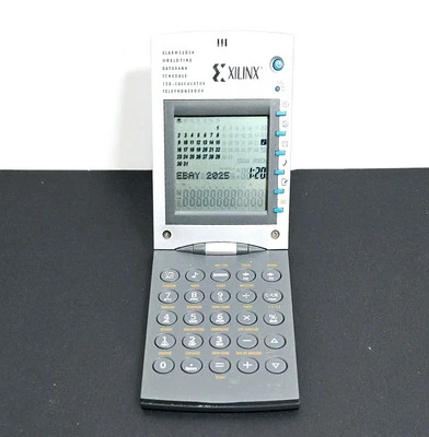 XILINX Flip Desktop Alarm Clock World Time Databank Calculator Telephone Book - Image 1 of 4