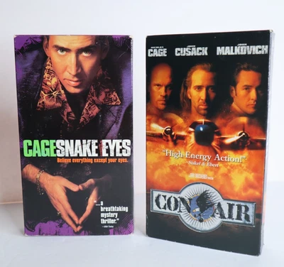 Two VHS Movies - Cage Snake Eyes and Con Air - Nicolas Cage Foto 1 de 4