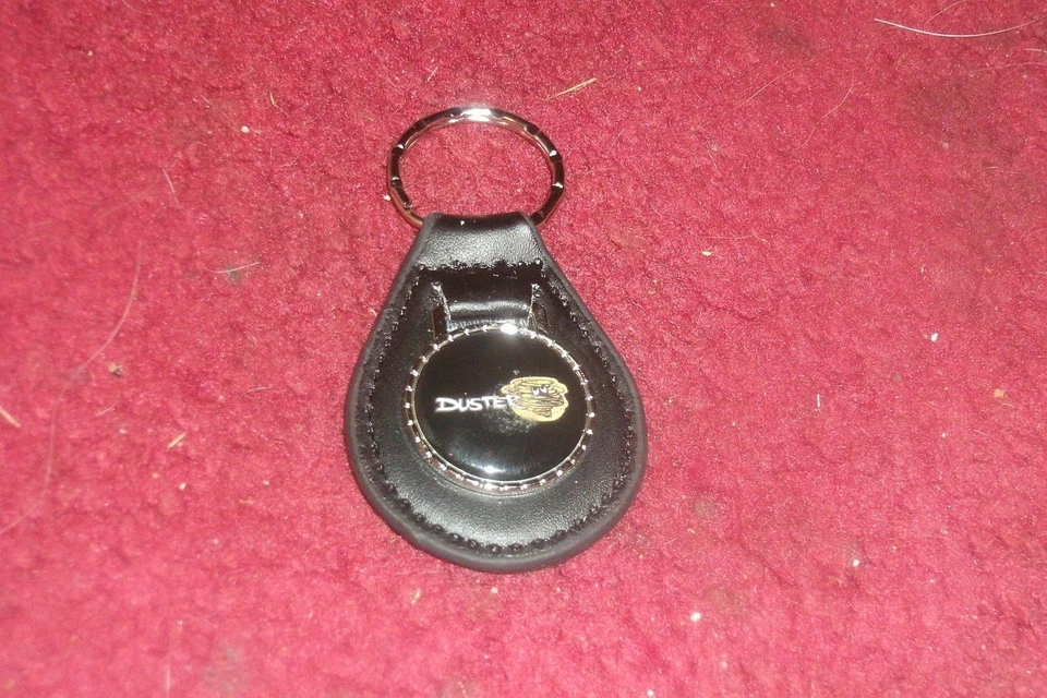 1970 1971 1972 1973 1974 1975 1976 PLYMOUTH DUSTER CLOUD LOGO KEYCHAIN BLACK - Image 1 of 1