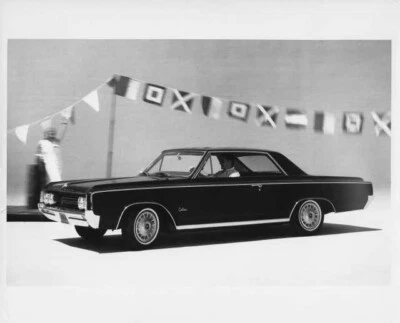 1964 Oldsmobile F-85 Cutlass Holiday Coupe Press Photo and Release 0080 - Image 1 of 2