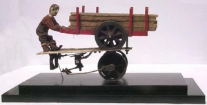 Man on wood wagon from an extraordinary collection of hand carved figures. - Picture 1 of 11