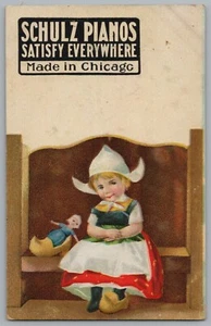 Schulz Pianos Chicago Illinois IL Dutch Girl Wooden Shoes & Doll Postcard c1910 - Picture 1 of 2