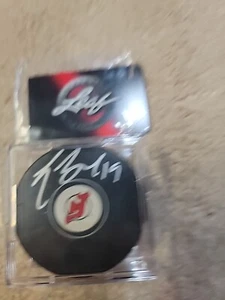 TRAVIS ZAJAC SIGNED AUTOGRAPH UND NEW JERSEY DEVILS HOCKEY PUCK w/ LEAF COA CARD - Picture 1 of 3