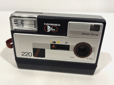 HANIMEX DISC 220 MOTOR DRIVE SILVER VINTAGE CAMERA W/ BUILT-IN FLASH & STRAP - Image 1 of 4