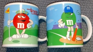 Zwei (2) Kaffeetassen mit Sportmotiven von M&M’s Candy Collection - Bild 1 von 2