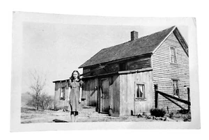 Vtg Photo Girl Standing In Front Of Her Old Run Down house - Picture 1 of 3