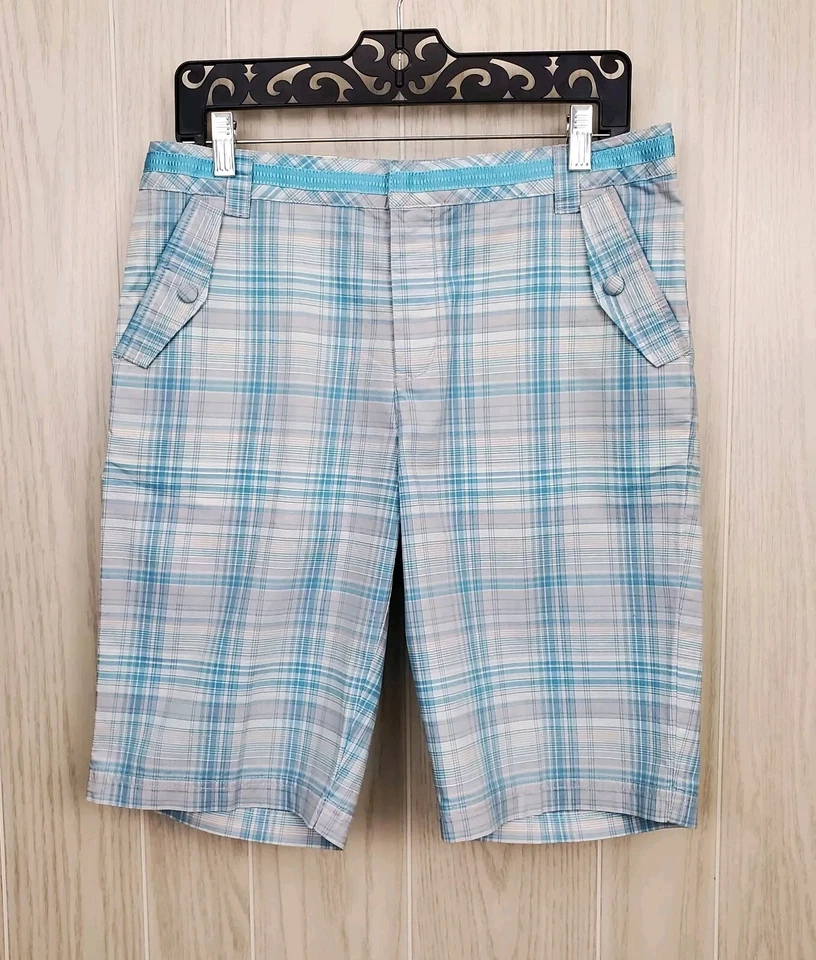 Cinturón corto de golf Greg Norman azul bebé gris y blanco a cuadros talla 8 cinta sintética Foto 1 de 4