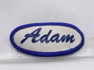 ADAM  USED SILK SCREEN VINTAGE SEW ON NAME PATCH TAGS OVAL BLUE ON WHITE - Picture 1 of 2