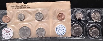 1986 U.S. P & D SOUVENIR SET - TATTERED ENVELOPE - COINS ARE UNHARMED - Image 1 of 2