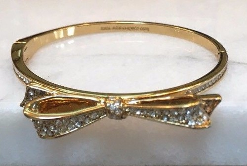 BRACCIALE KATE SPADE PLACCATO ORO PAVÈ CRISTALLI NOTE D'AMORE GRANDE FIOCCO US INtime OTTIMEioni