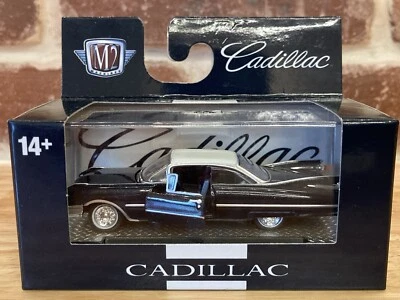 M2 Machines 1/64 1959 CADILLAC Series 62 Black NIP w/Stand &Case Doors/Hood Open - Image 1 of 4