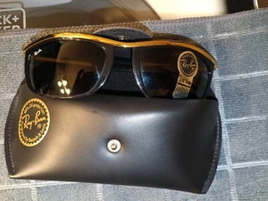 For sale is a vintage pair of black with gold trim Ray Ban sunglassesl. - Picture 1 of 4