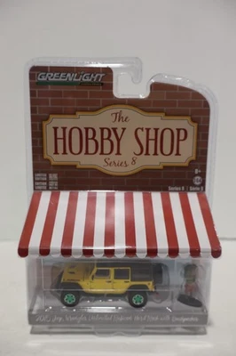 Jeep Wrangler Unlimited Rubicon 2015 Greenlight Hobby Shop con Backpacker Chase Foto 1 de 3