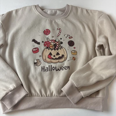Girls Halloween Pullover sweatshirt size medium cream color pumpkin candy - Image 1 of 4