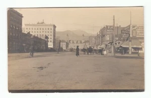 Vintage RPPC Photo Postcard Elk Hotel Main Street Drugs Pool Cigar Lady in Black - Picture 1 of 2