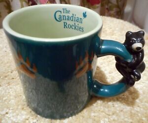 The Canadian Rockies Coffee Mug. Bear Figure on Handle. Green Ceramic. 3-¾"