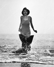 0944-006 Irene Ware in her thigh high fishing boots standing in the waves 944-06