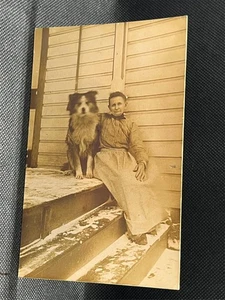 RPPC WOMAN SITTING ON A PORCH WITH A COLLIE DOG - Picture 1 of 2