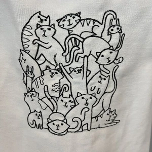 Katzenschürze weiß schwarz bestickt Kätzchen Caboodle Katzengruppe Neu mit Etikett - Bild 1 von 6