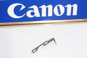 208660 CANON AE-1 PROGRAMM FILM TÜRVERRIEGELUNG REPARATURTEIL GEBRAUCHT - Bild 1 von 1