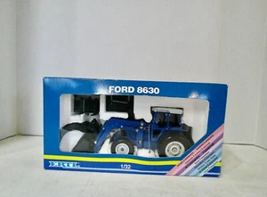 1/32 Ertl Ford 8630 Tractor with loader and attachments in box. - Picture 1 of 6