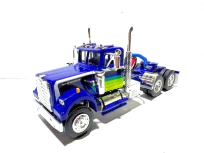 DCP  FIRST GEAR 1/64 SCALE WHITE WESTERN STAR 4900 DAY CAB BLUE, COLORED STRIPES - Image 1 of 4