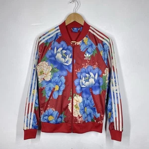 Chaqueta deportiva floral Adidas para mujer 10 roja Chita cremallera Top Farm Rio Superstar SST - Imagen 1 de 9