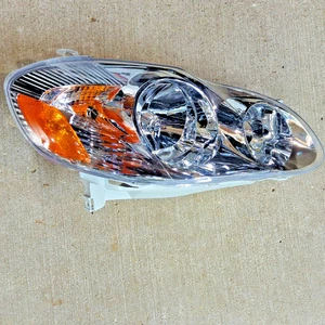 81110-02200 for 2003-2004 Toyota Corolla RH Passenger Side Headlamp Gray Housing - Picture 1 of 12