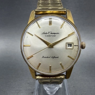 Reloj calendario Seiko Champion para hombre 35 mm esfera plateada tono dorado fecha manual funciona Foto 1 de 4