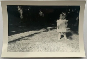 Vintage 1940s Snapshot Cute Ornery Young Girl in Yard Man / Father in Background - Picture 1 of 2