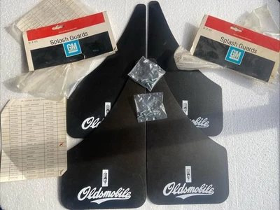 60s 70s  NOS GM 997703 OLDSMOBILE SPLASH GUARDS Black W/ White LOGO Mud Flaps - Image 1 of 4