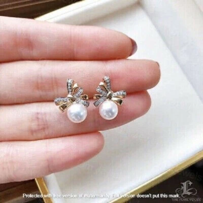 Aretes con nudo y lazo de diamantes de corte redondo de 2 quilates acabado en oro amarillo de 14 quilates Foto 1 de 4