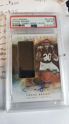 2023 Panini Origins - Rookie Jumbo Jersey Autographs Chase Brown (RC) PSA 8 - Image 1 of 2