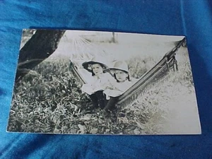 Early 20thc TWIN GIRLS Sitting In a HAMMOCK REAL PHOTO POSTCARD - Picture 1 of 2