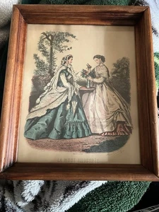 A Pair of Framed La Mode fashions two ladies posing - Picture 1 of 3