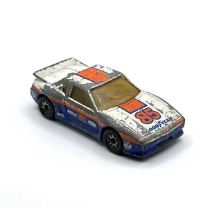 Matchbox Pontiac Fiero White 1985 Goodyear Made in Macau 1:56 - Junkyard Diorama - Picture 1 of 4