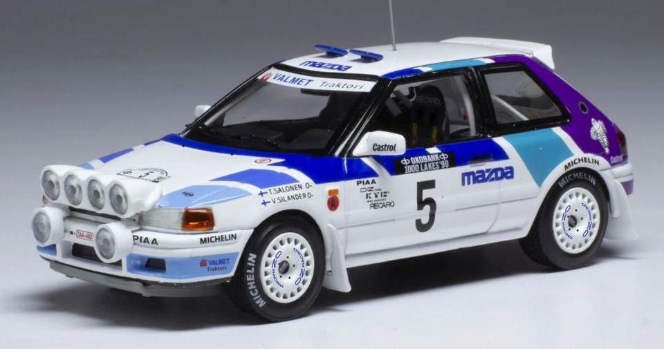 IXO 1:43 Scale Mazda 323 GTX #5 1000 Lakes Rallye 1990 w/Lights T.Salonen - Image 1 of 1