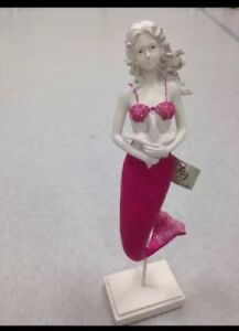 Beautiful fuchsia mermaid with starfish on pedestal approximately 17"