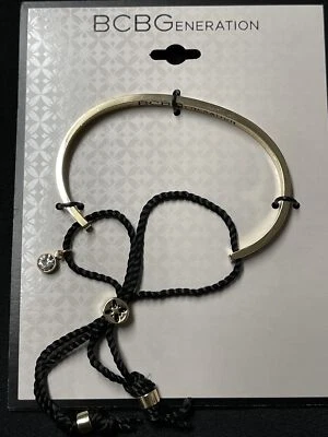 BCBGeneration Brazalete Dorado con Borlas Negras y Estrás “PARA SIEMPRE Y PARA SIEMPRE” Foto 1 de 4