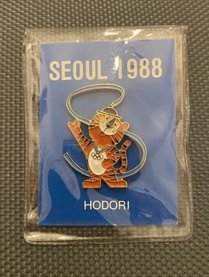 Producto Oficial de los Juegos Olímpicos de Verano de Seúl 1988 - Prendedor Sombrero Solapa Esmalte Mascota Nuevo de Lote Antiguo Foto 1 de 2