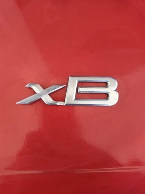 2004-2015 Scion xB emblema logotipo símbolo insignia maletero puerta trasera plateada OEM G15 Foto 1 de 2