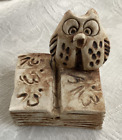 Ceramic owl sitting on a book