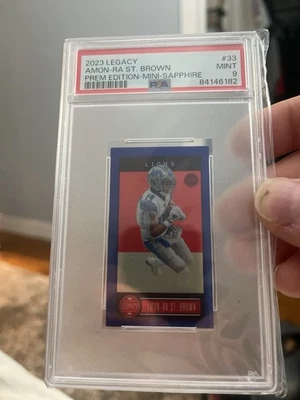 2023 Legacy Mini Sapphire Prem Edition  Amon-Ra St. Brown Lions 15/20 #33 PSA 9 - Image 1 of 2