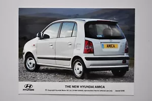 Car Press Photo - 2006 Hyundai Amica - White / Metallic - Side / Back View - Picture 1 of 1